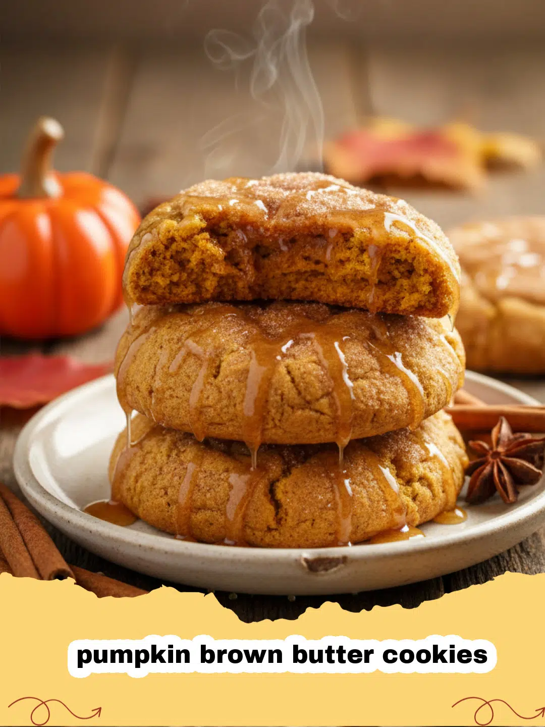 A stack of chewy pumpkin brown butter cookies on a rustic wooden board surrounded by fall leaves.