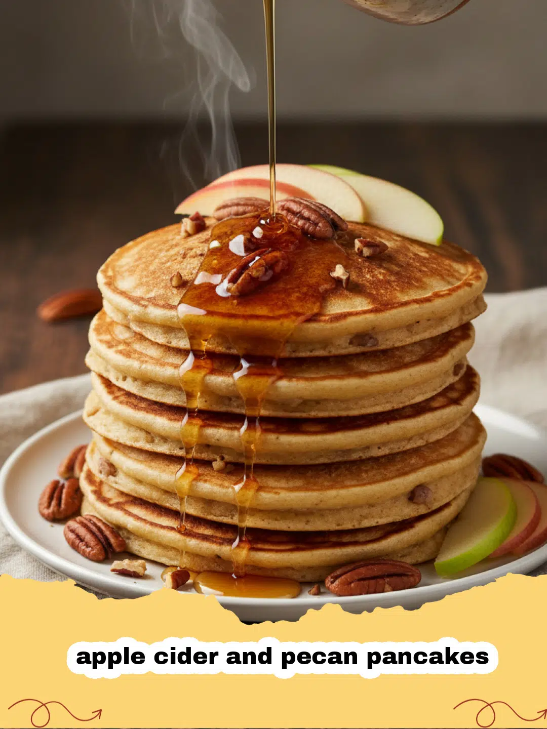 A stack of fluffy apple cider and pecan pancakes topped with syrup and crushed pecans.