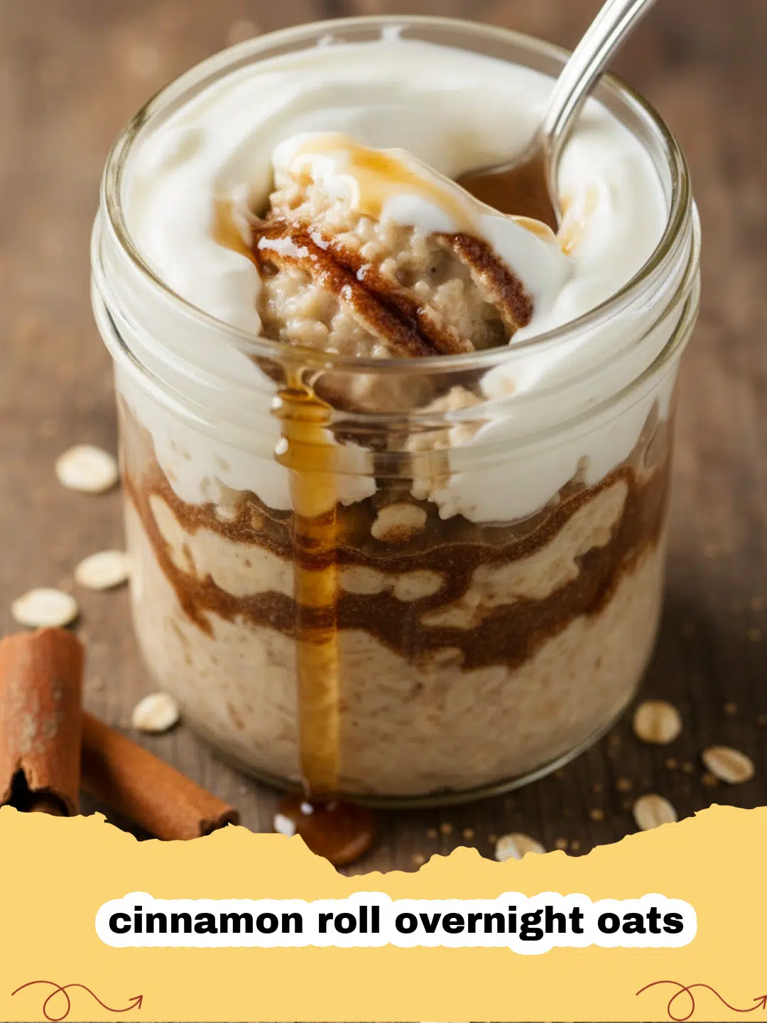 Close-up of a jar of creamy cinnamon roll overnight oats with a white cream cheese swirl on top and a sprinkle of cinnamon.