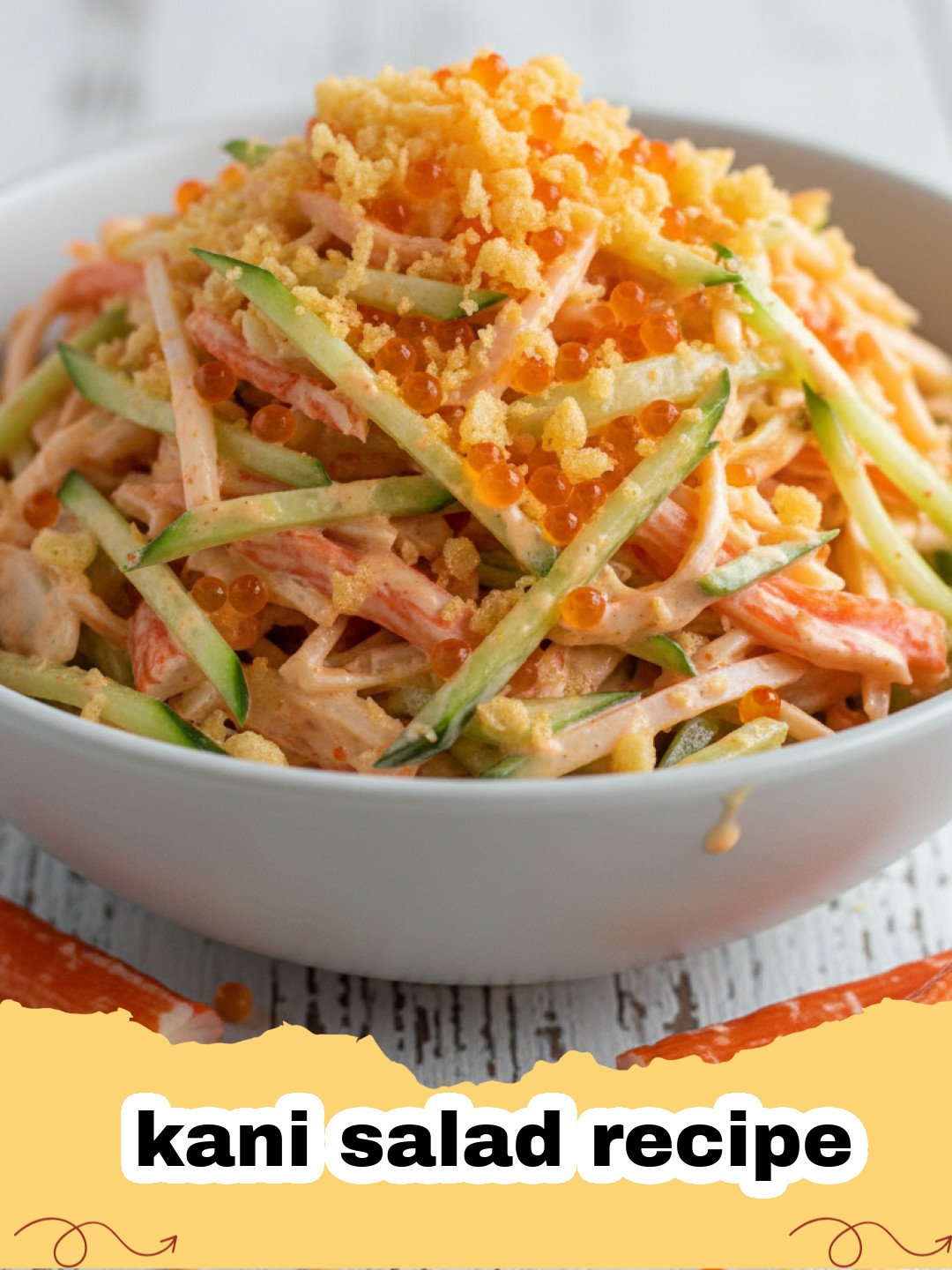 kani salad recipe - Close-up of a vibrant, creamy kani salad in a white bowl, garnished with masago and green onions.