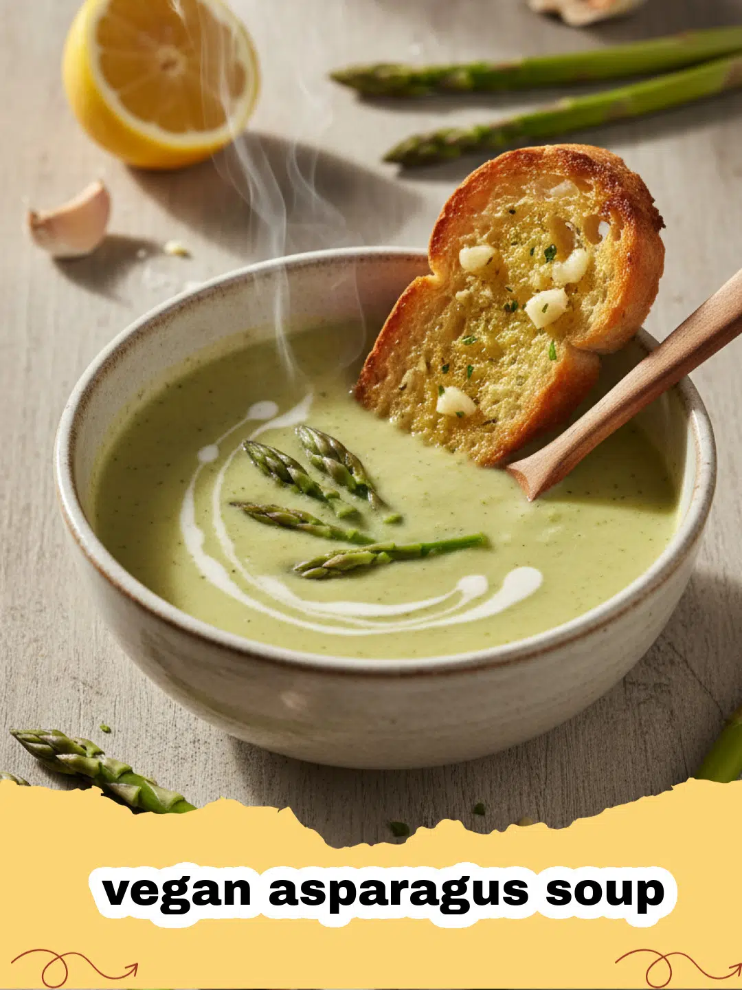 Bowl of creamy vegan asparagus soup garnished with fresh asparagus tips and a swirl of olive oil, placed on a rustic wooden table.