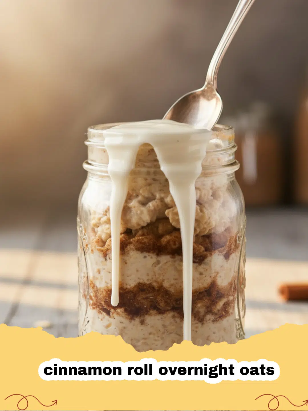 A jar of cinnamon roll overnight oats topped with a swirl of cream cheese frosting, a sprinkle of cinnamon, and fresh berries.