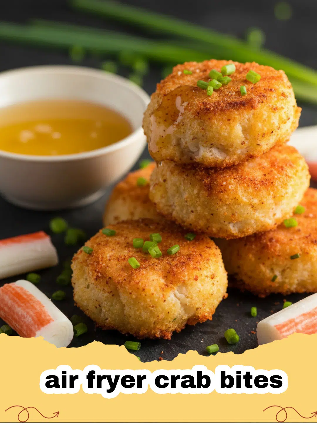 Golden brown air fryer crab bites stacked on a plate with lemon wedges and a small bowl of dipping sauce.