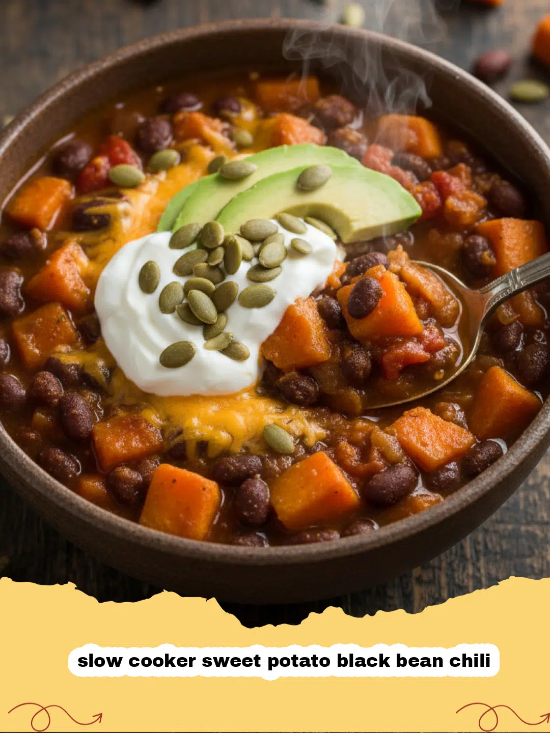 A steaming bowl of vibrant slow cooker sweet potato black bean chili, garnished with fresh cilantro and a dollop of sour cream.
