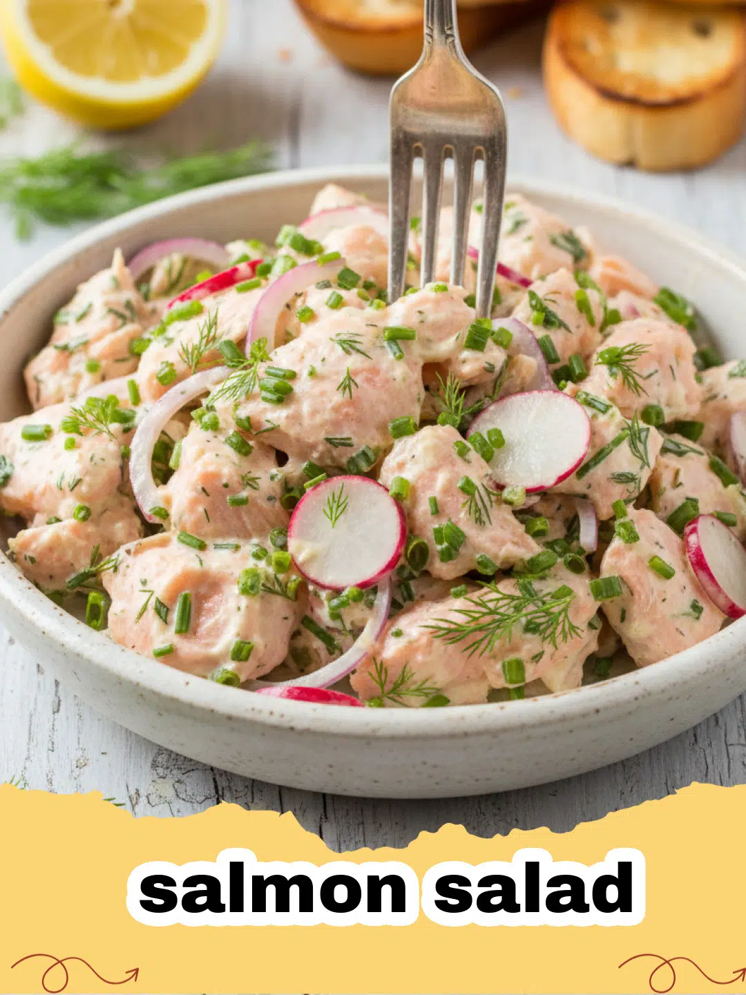 Close-up of creamy salmon salad with fresh dill and celery in a white bowl, ready to be served.