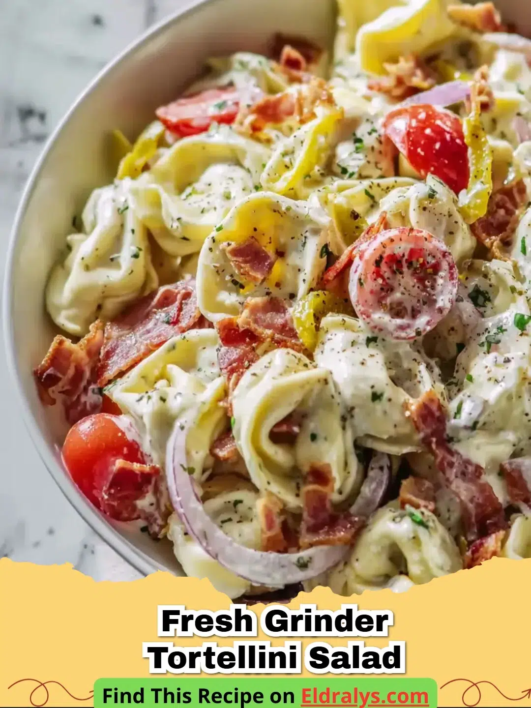 A large bowl of Fresh Grinder Tortellini Salad with creamy dressing and Italian meats.