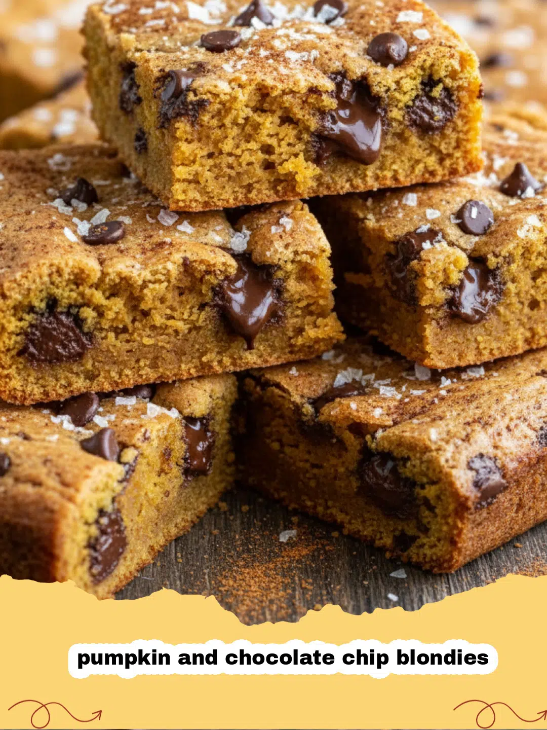 A tray of freshly baked pumpkin and chocolate chip blondies sliced into squares.