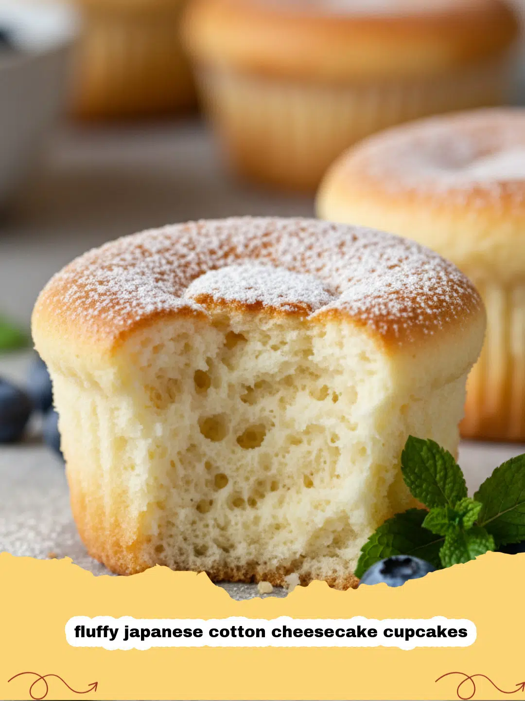 fluffy japanese cotton cheesecake cupcakes - A tray of golden-brown fluffy Japanese cotton cheesecake cupcakes, some topped with a light dusting of powdered sugar, with a soft focus background.