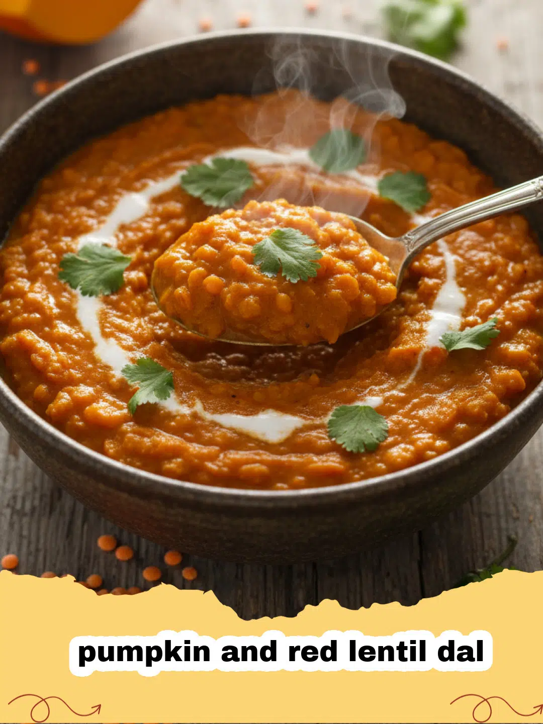 A bowl of vibrant orange pumpkin and red lentil dal topped with cilantro and lime