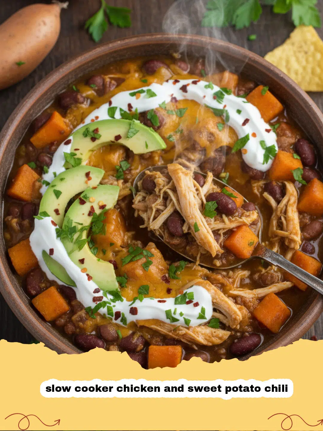 A steaming bowl of hearty slow cooker chicken and sweet potato chili, garnished with fresh cilantro and a dollop of sour cream.