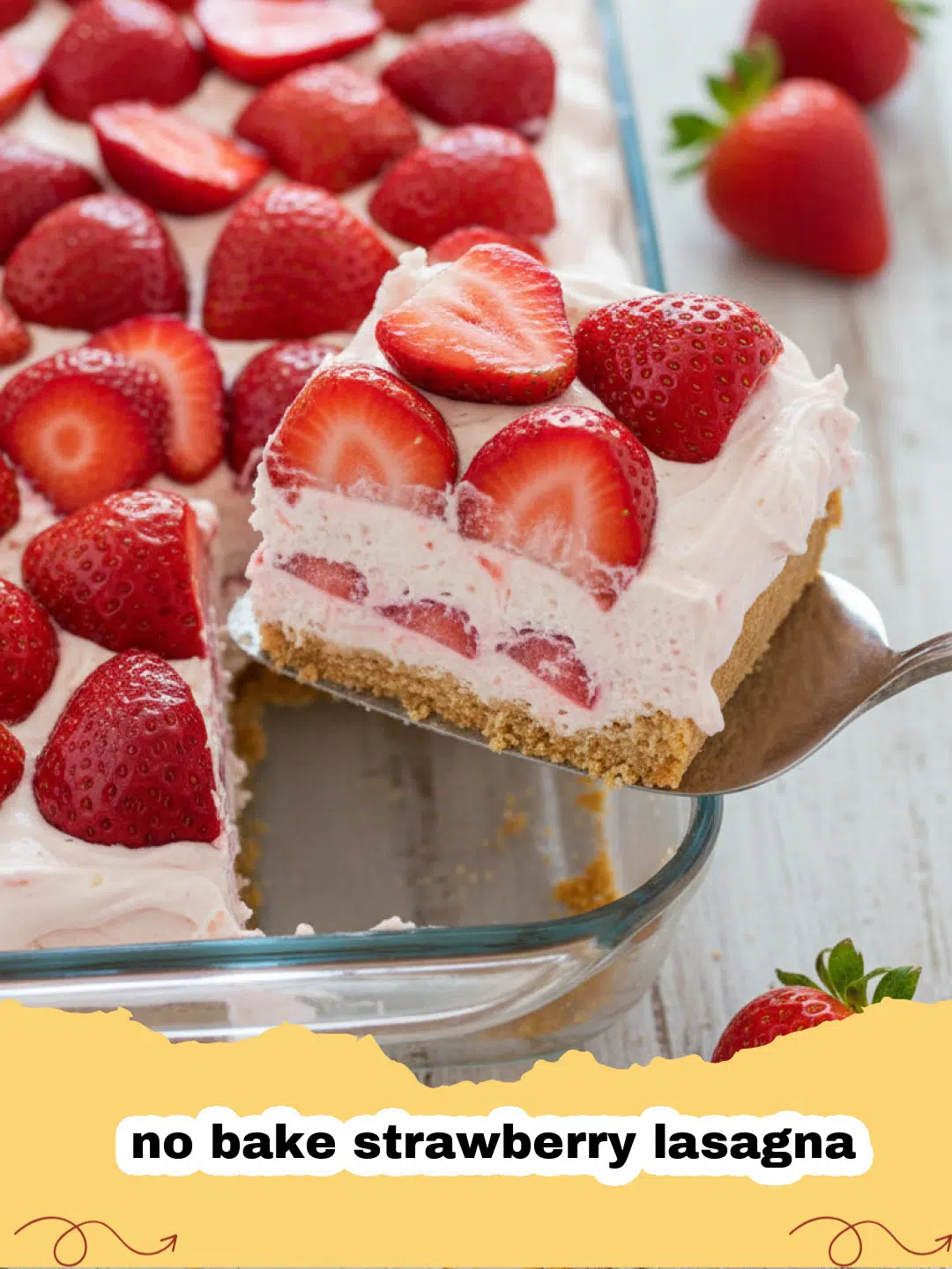 A perfectly sliced square of no bake strawberry lasagna in a white serving dish, garnished with fresh strawberries.