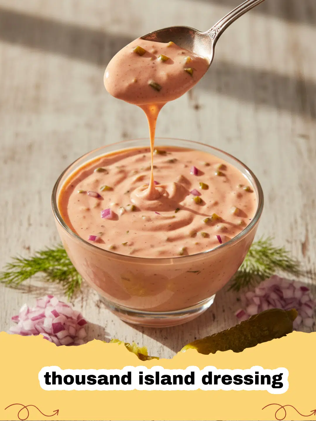thousand island dressing - Creamy homemade Thousand Island dressing in a glass bowl with fresh ingredients scattered around.