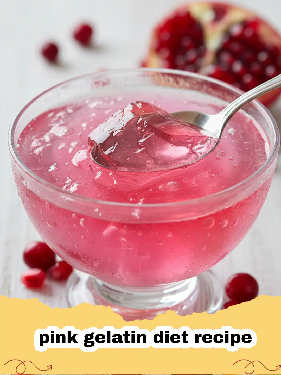 Close-up of a refreshing pink gelatin diet recipe in a clear glass bowl, garnished with fresh raspberries and mint.