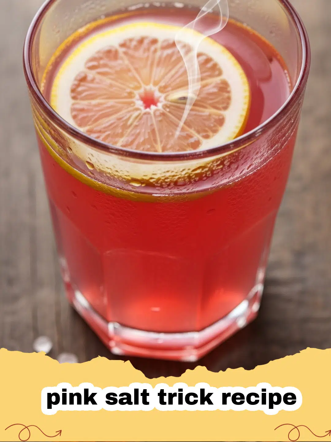A glass of the pink salt trick recipe drink with a slice of orange on the rim.