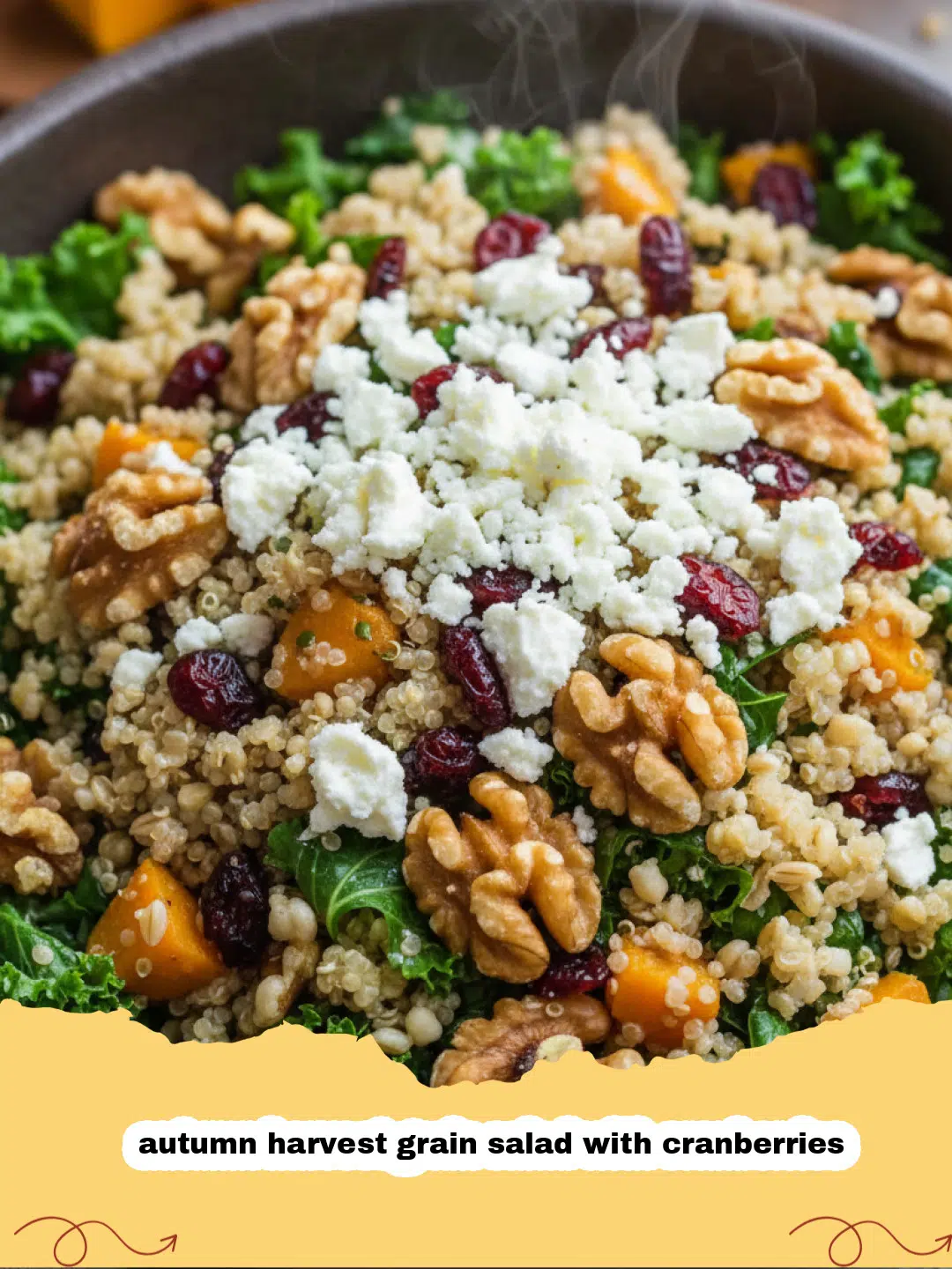A large wooden bowl filled with autumn harvest grain salad with cranberries, featuring roasted squash, kale, and pecans.