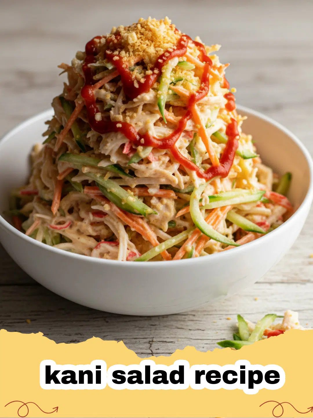 kani salad recipe - A close-up of a vibrant, creamy Kani Salad topped with toasted panko and fresh scallions, served in a white bowl.
