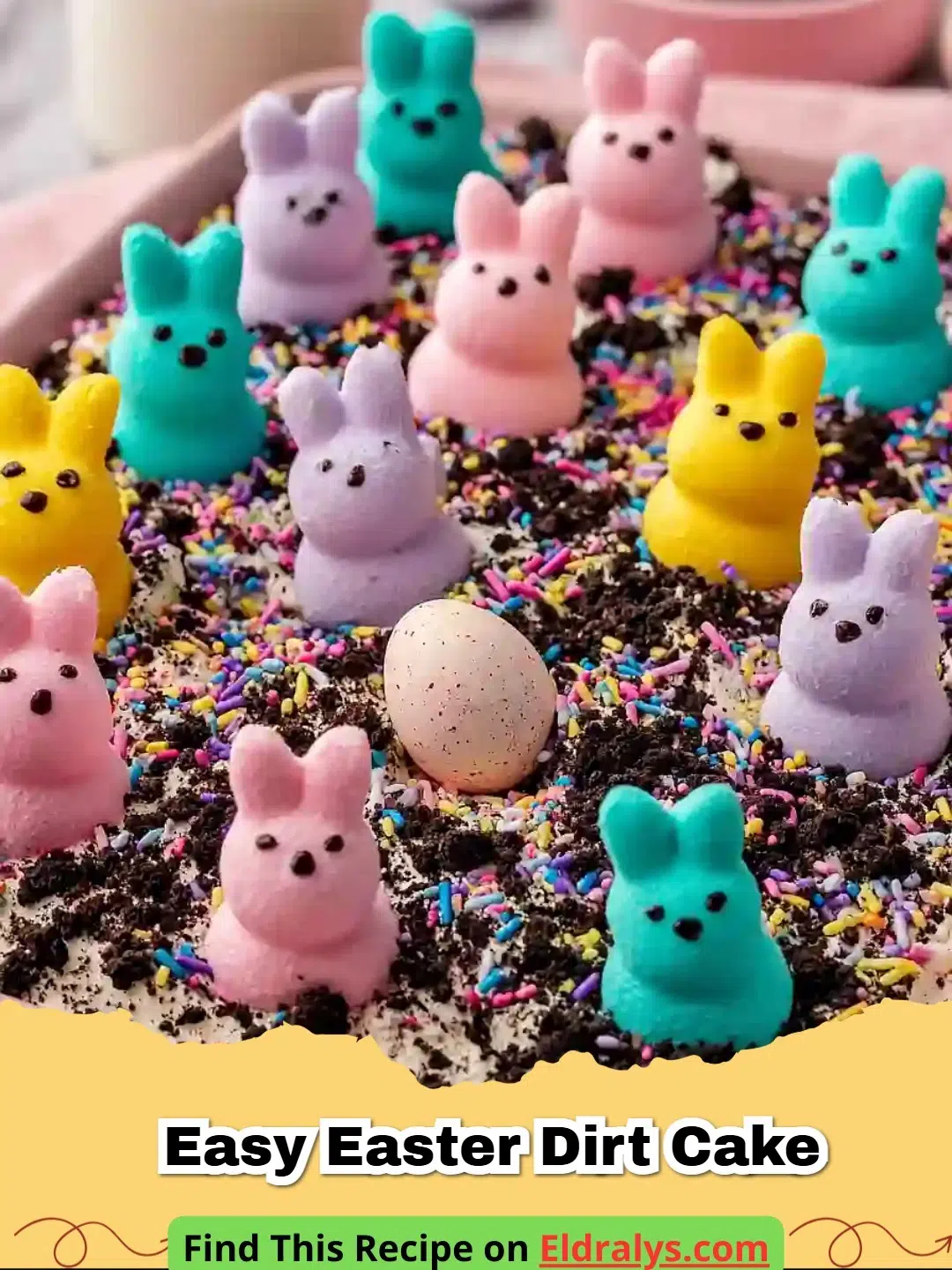 A close up of an Easy Easter Dirt Cake in a glass bowl with Peeps and chocolate eggs.