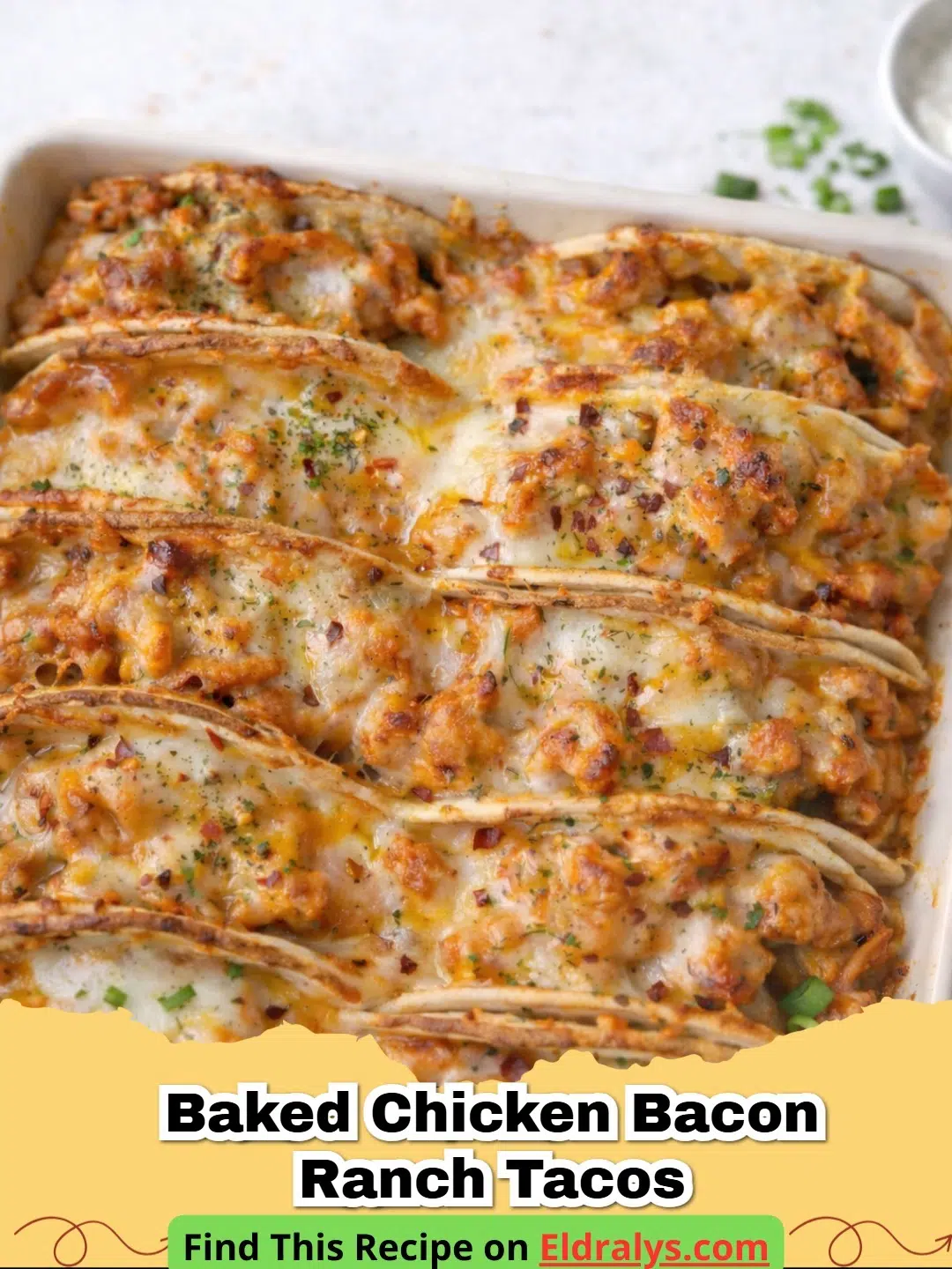 A tray of golden Baked Chicken Bacon Ranch Tacos topped with fresh green onions.