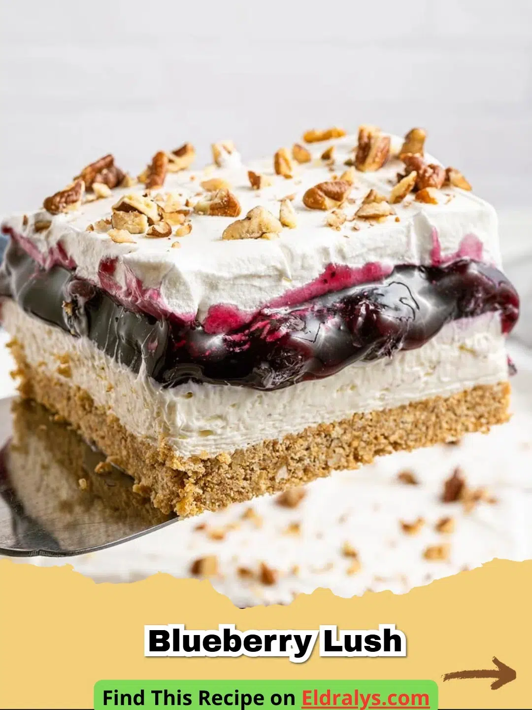 A close up slice of layered Blueberry Lush with a pecan crust and whipped cream topping.