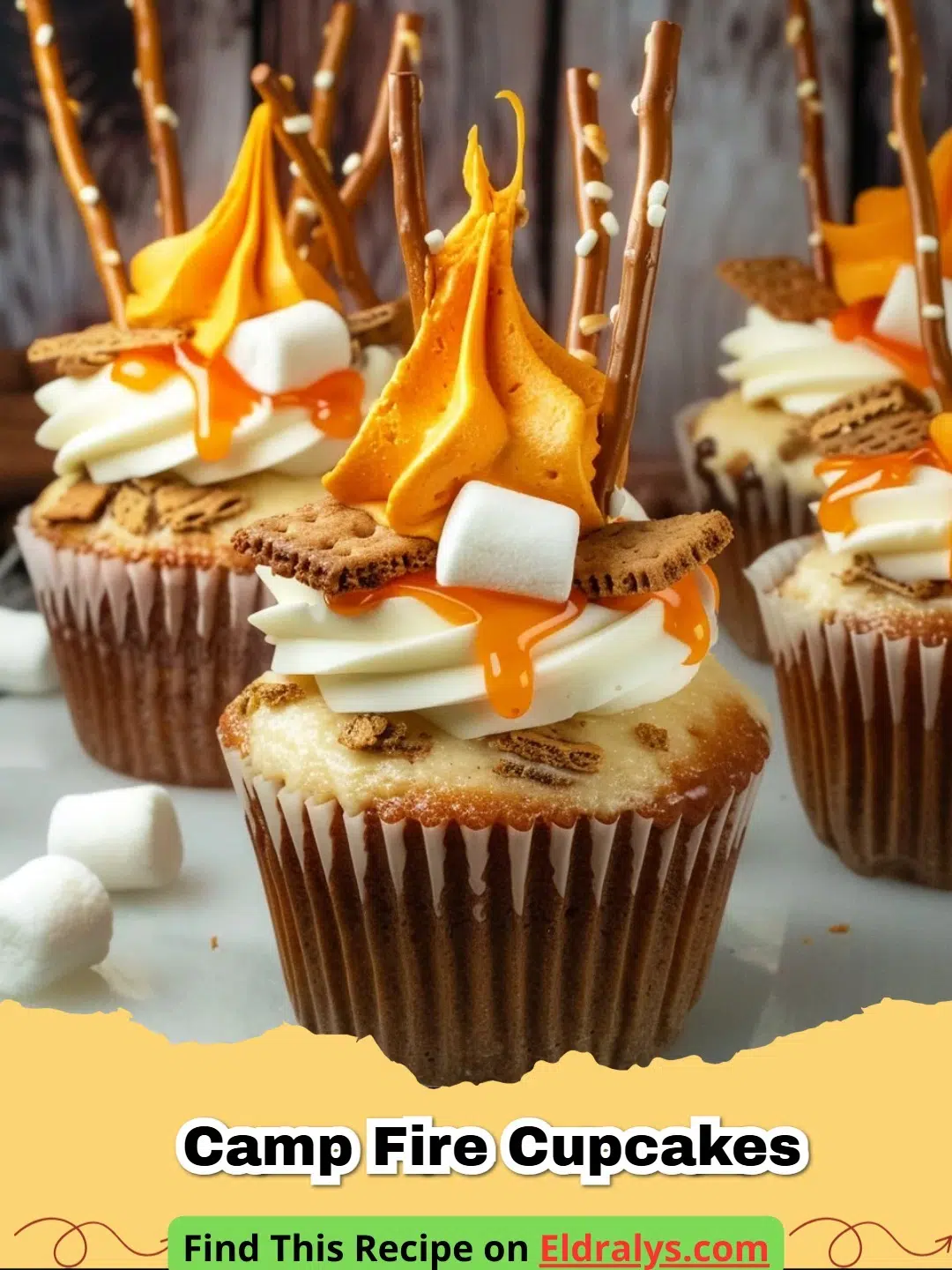 Close up of Camp Fire Cupcakes with pretzel logs and red orange frosting flames