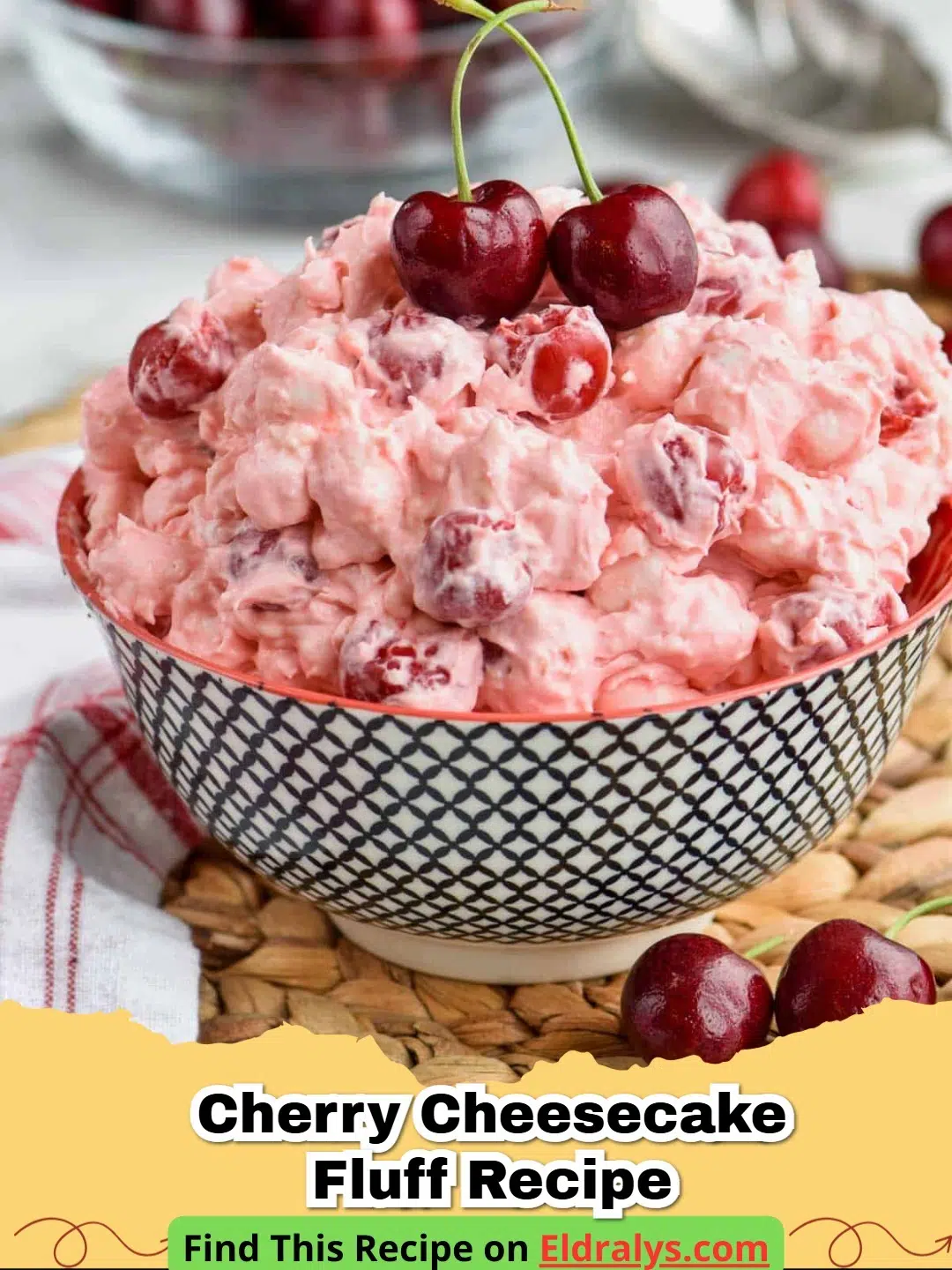 Cherry Cheesecake Fluff Recipe - A large glass bowl filled with pink Cherry Cheesecake Fluff topped with fresh cherries.