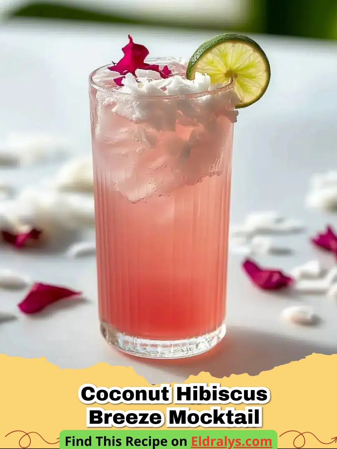 A glass of Coconut Hibiscus Breeze Mocktail with layers of red and white