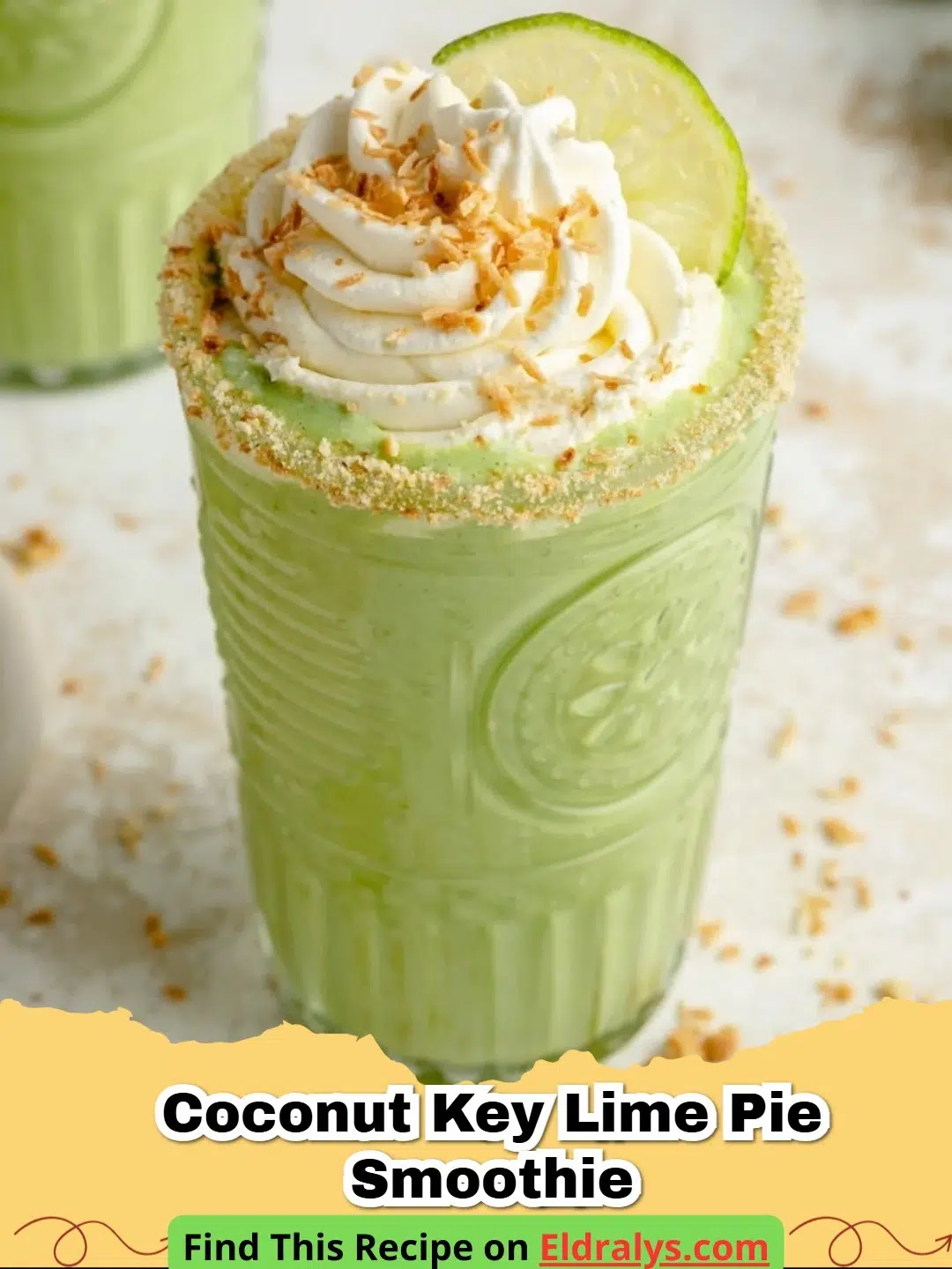 A creamy Coconut Key Lime Pie Smoothie in a tall glass garnished with lime zest and graham crackers.