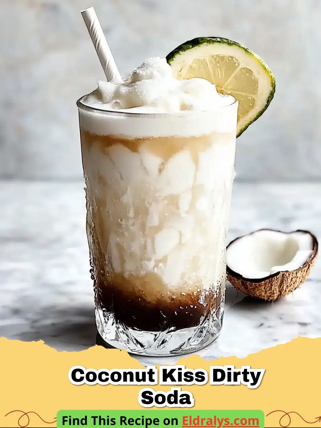 A glass of Coconut Kiss Dirty Soda with cream swirling through and a lime wedge garnish.