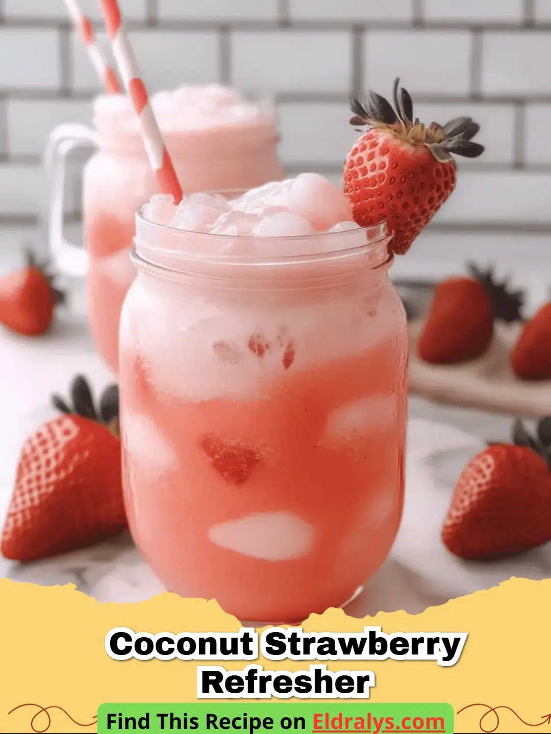 A glass of creamy pink Coconut Strawberry Refresher with ice and strawberry slices