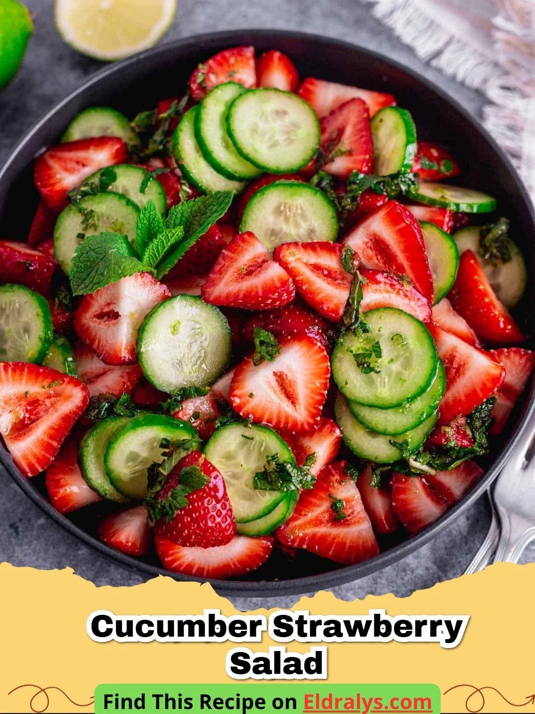 A close up of a fresh Cucumber Strawberry Salad with mint and feta in a white bowl