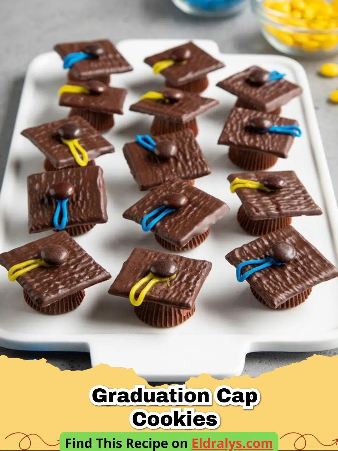 A tray of assembled Graduation Cap Cookies with tassels and buttons.