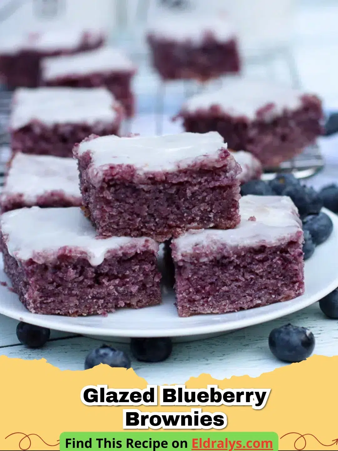 A tray of fudgy Glazed Blueberry Brownies with a drizzled lemon glaze and fresh berries.