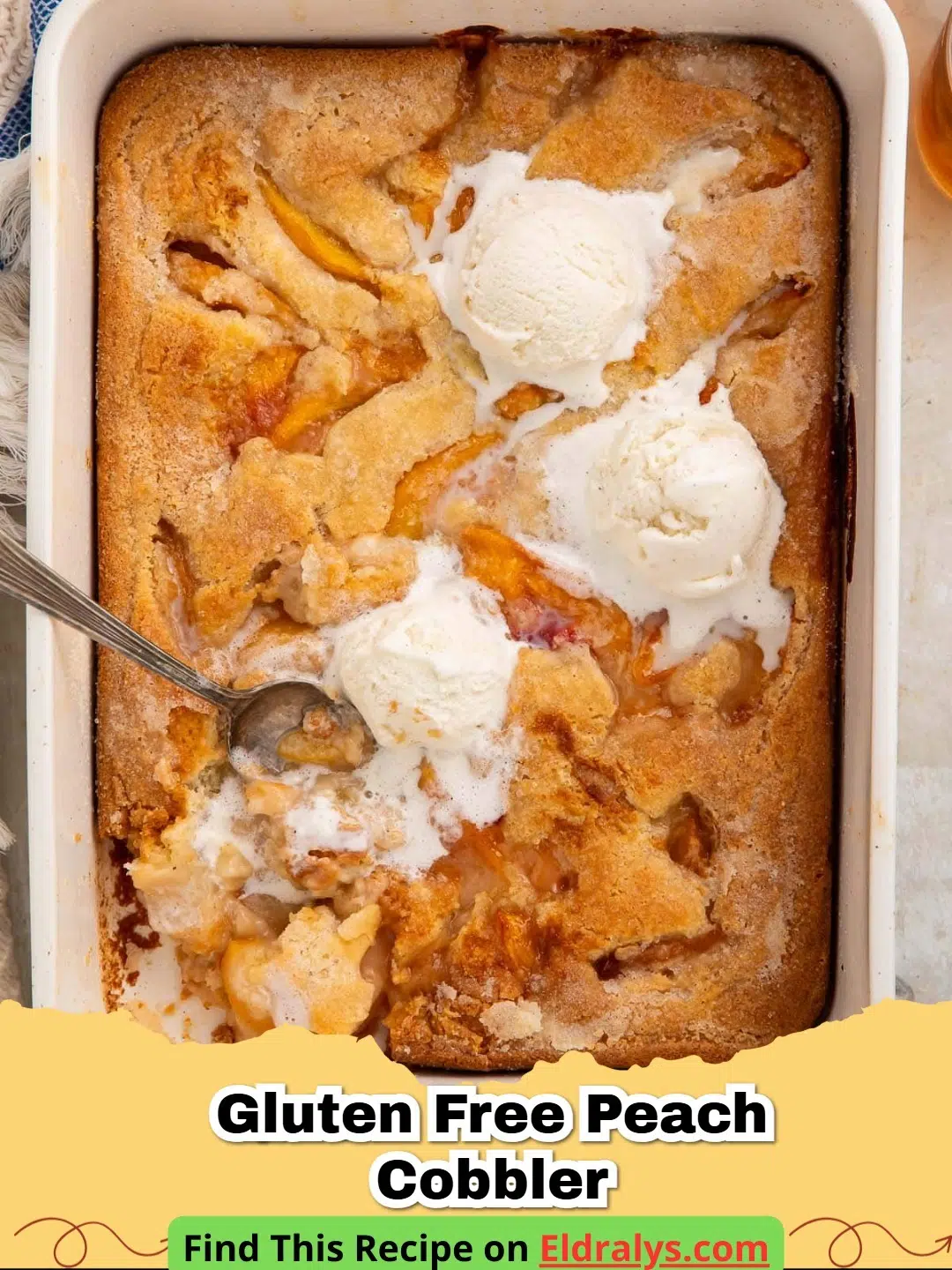 A close up of a golden Gluten Free Peach Cobbler in a white baking dish