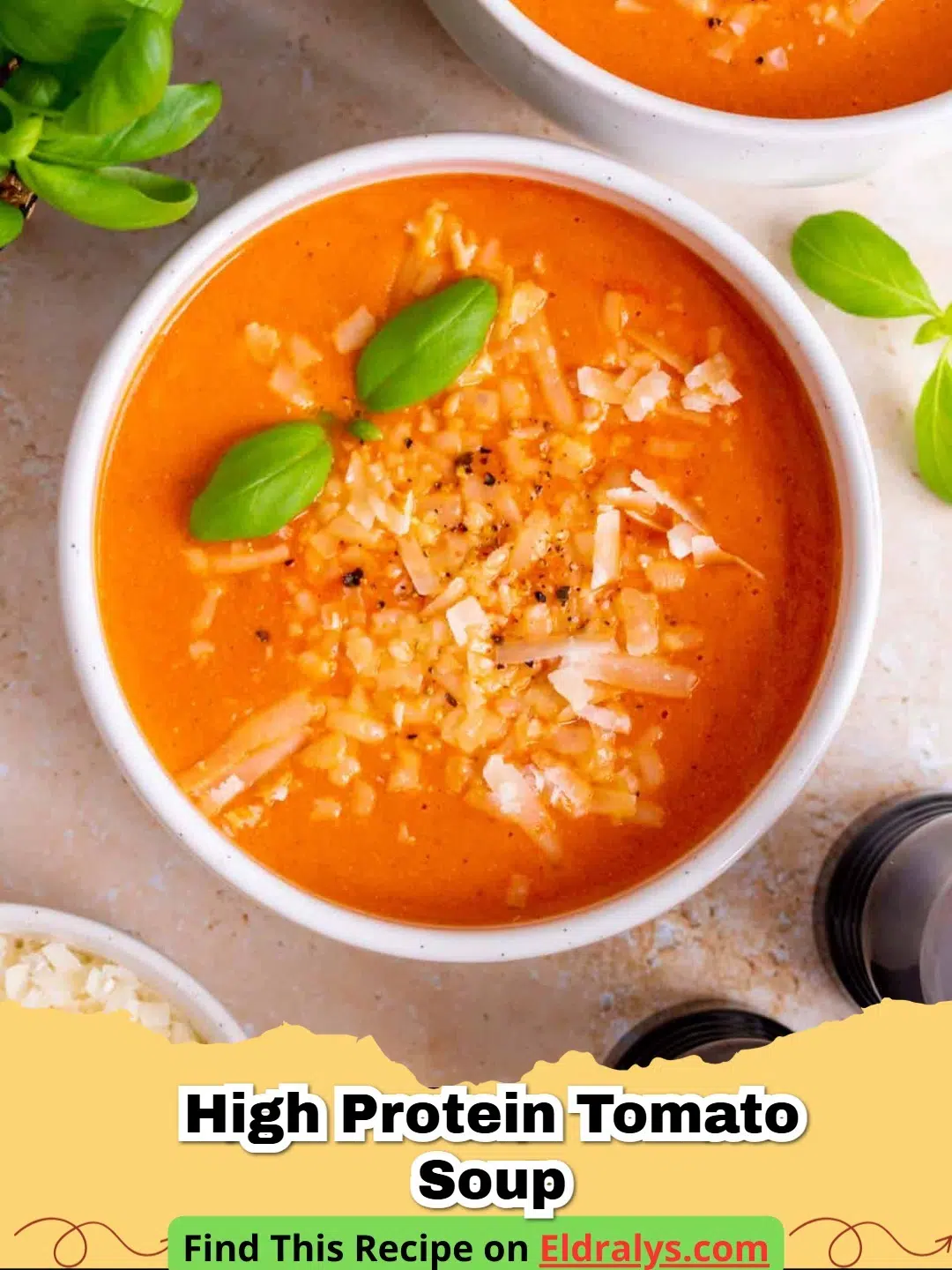 A bowl of creamy High Protein Tomato Soup garnished with fresh basil