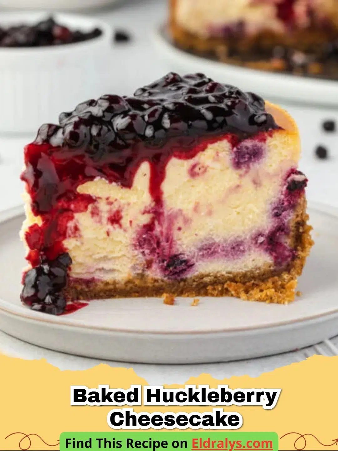 A slice of Huckleberry Cheesecake with a vibrant purple swirl and graham cracker crust.
