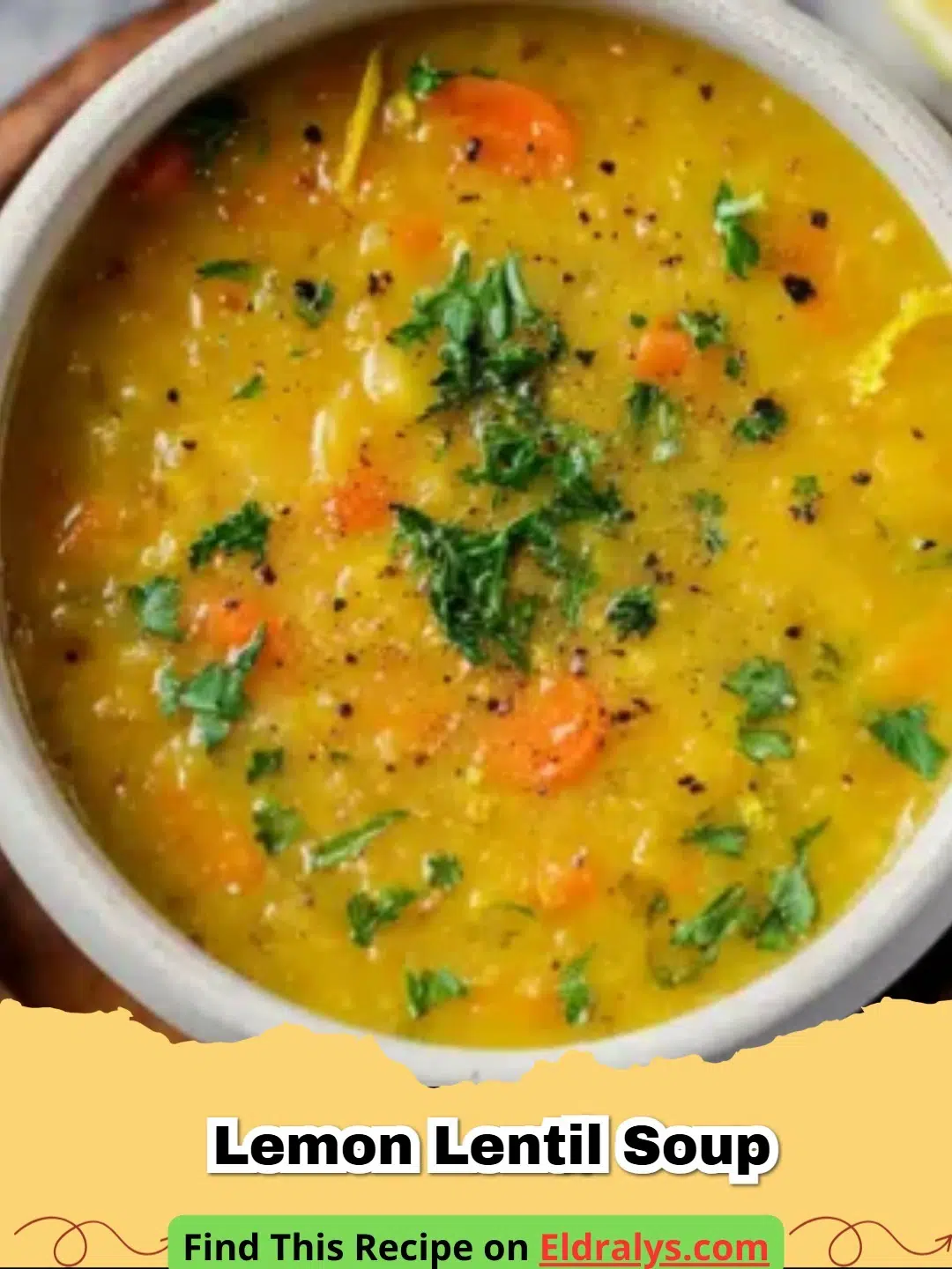 A steaming bowl of creamy Lemon Lentil Soup garnished with parsley and lemon slices