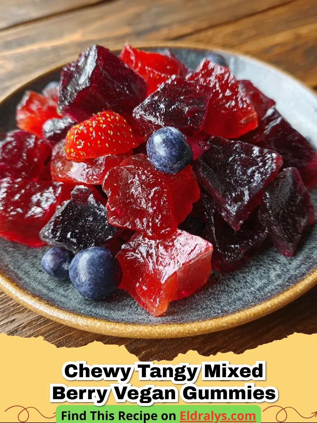 Close up of Chewy Tangy Mixed Berry Vegan Gummies in heart and bear shapes on a white plate.