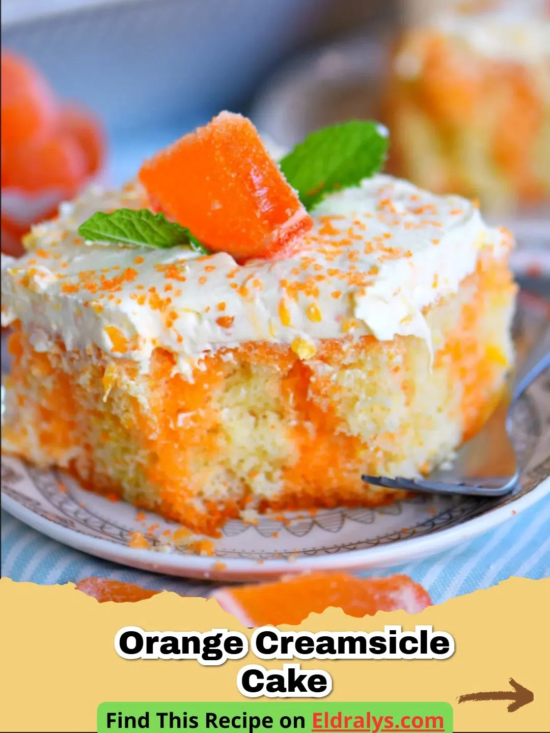 A beautiful slice of Orange Creamsicle Cake with orange frosting on a white plate.