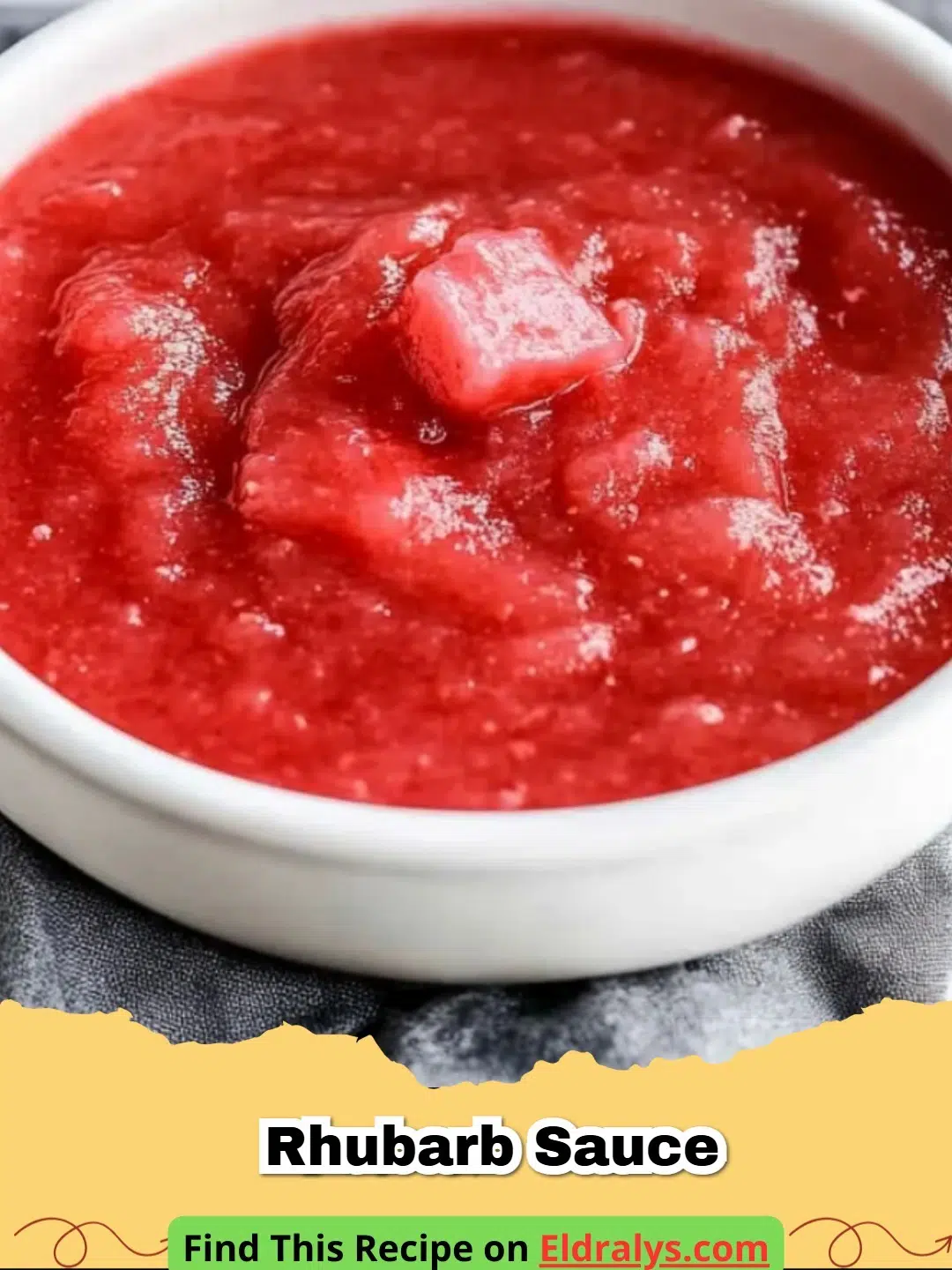A glass jar filled with vibrant pink Rhubarb Sauce and a spoon.