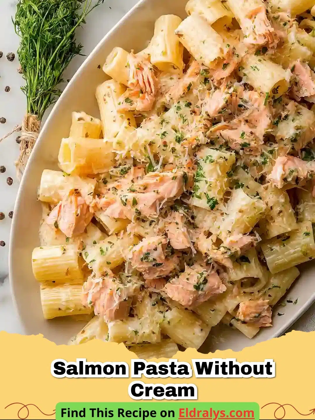 A close up shot of Salmon Pasta Without Cream garnished with parsley and lemon.