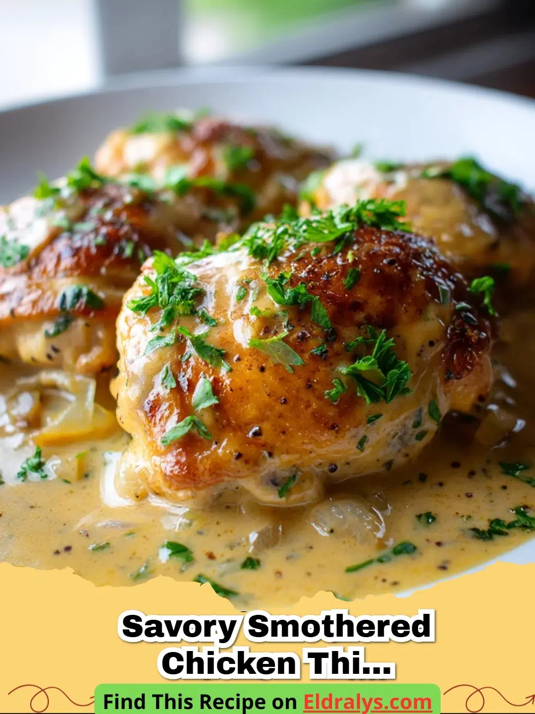 A close up shot of Savory Smothered Chicken Thighs Delight in a cast iron skillet with thick onion gravy and parsley.