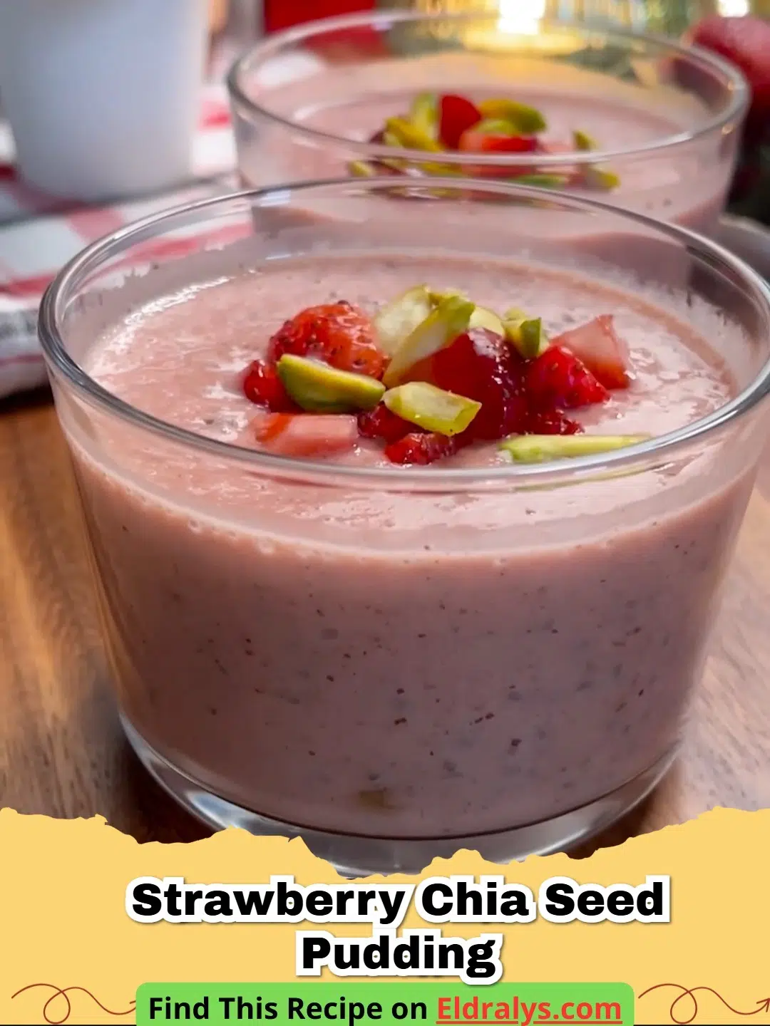 A glass jar filled with creamy pink Strawberry Chia Seed Pudding topped with fresh berries