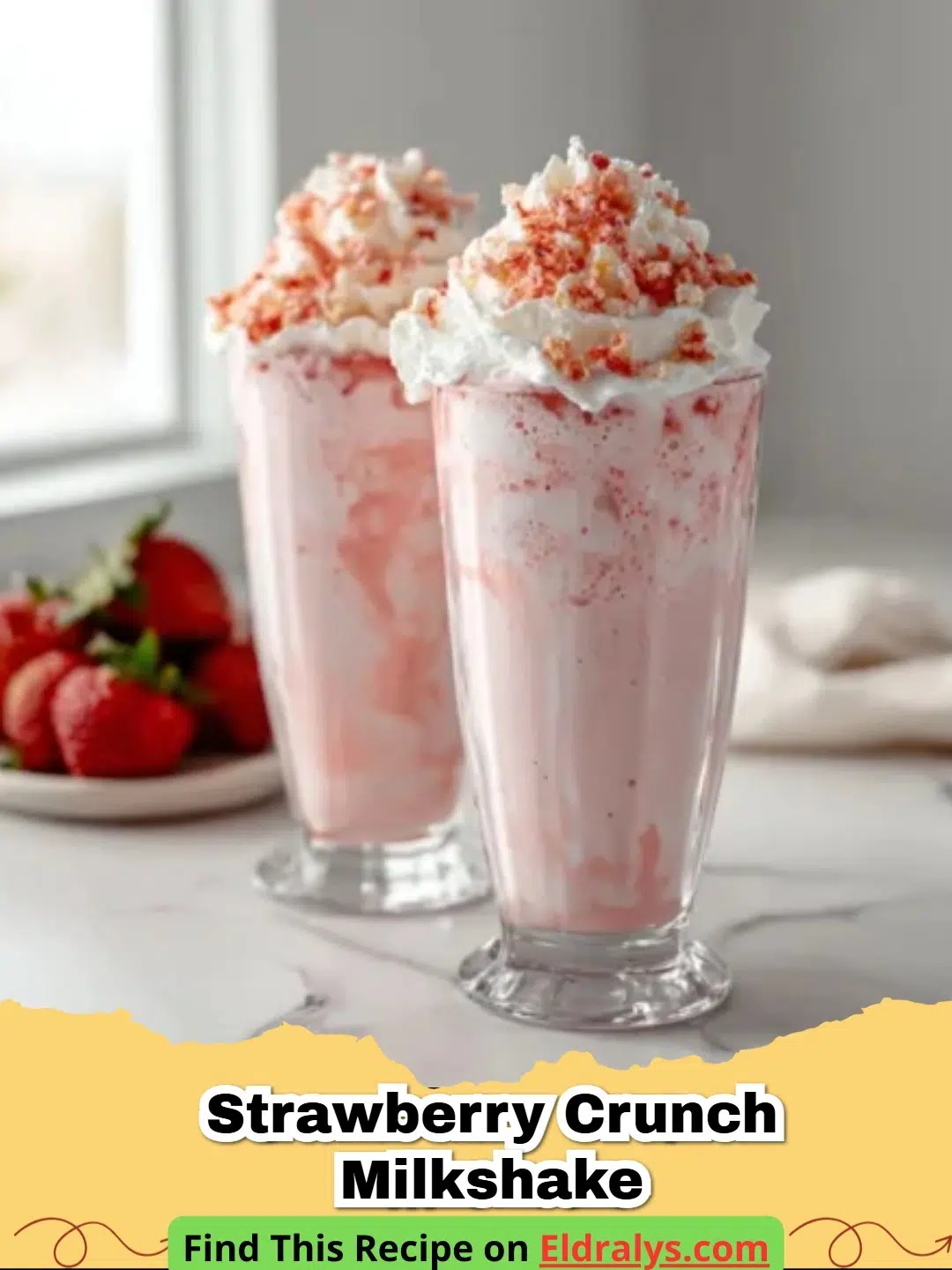A tall glass of Strawberry Crunch Milkshake with whipped cream and berry crumbles.