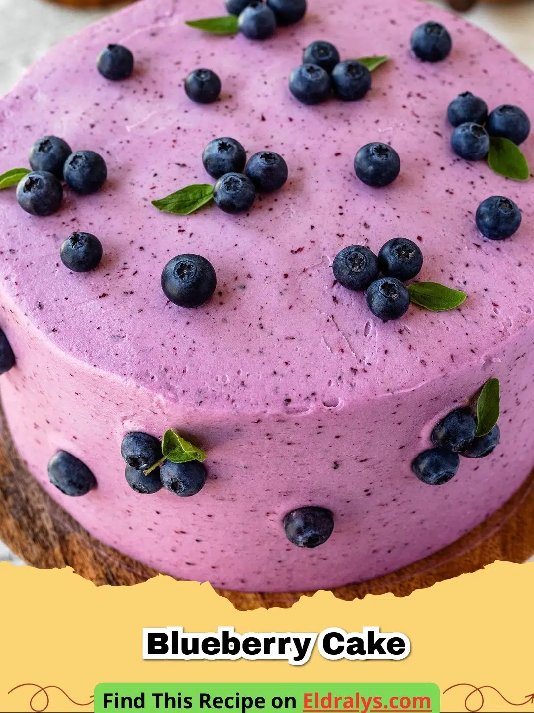 A close up shot of a moist Blueberry Cake slice on a white plate with fresh berries scattered around.