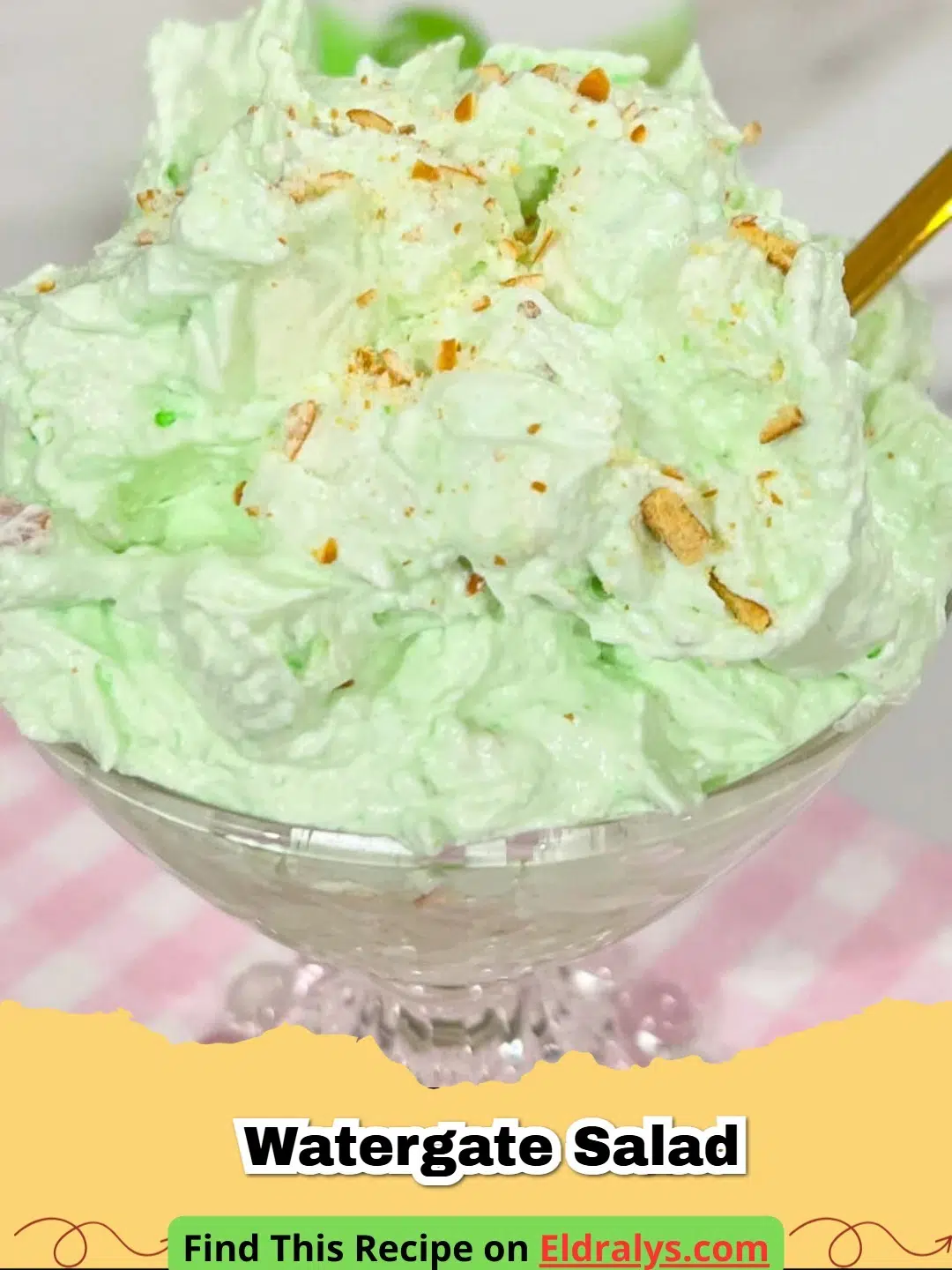 A close up of a bowl of creamy green Watergate Salad garnished with a cherry.