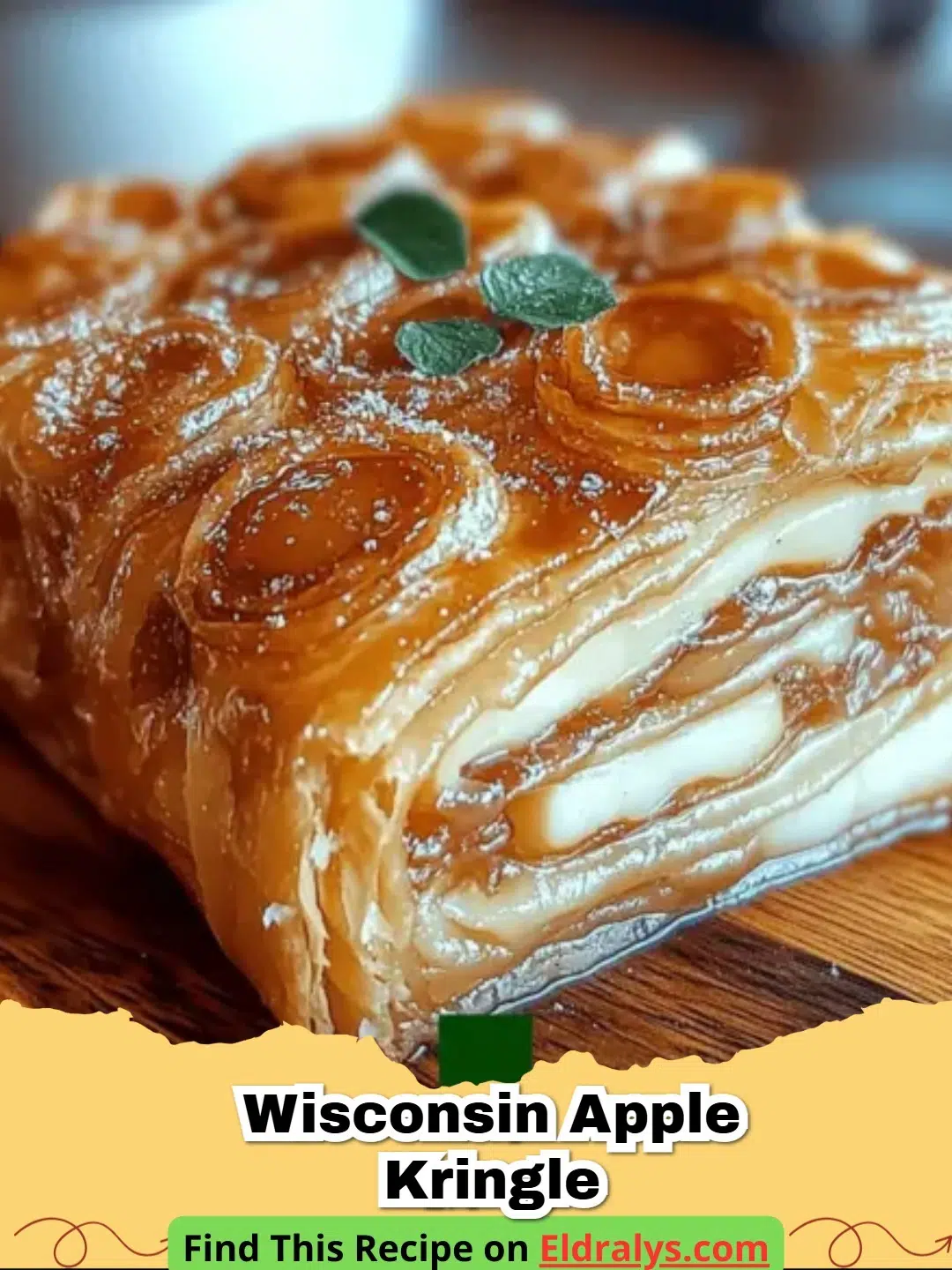 A golden brown Wisconsin Apple Kringle topped with vanilla glaze and sliced to show flaky layers.