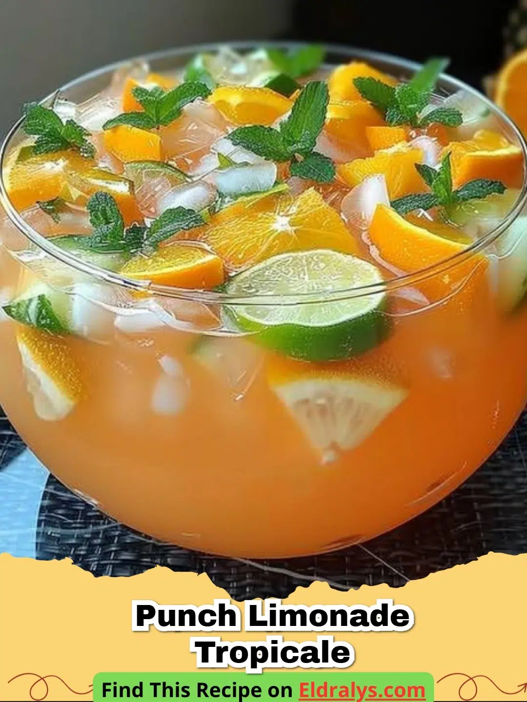 A glass of PUNCH LIMONADE TROPICALE À L’ANANAS with pineapple and mint garnishes.