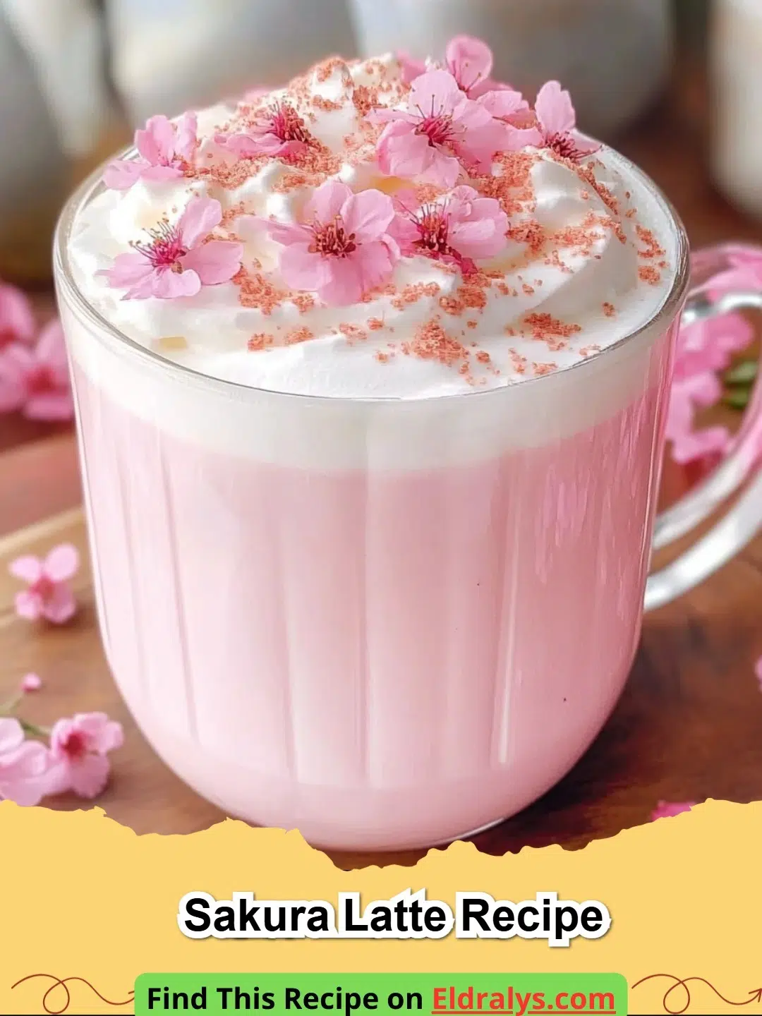 Sakura Latte Recipe - A beautiful pink Sakura Latte topped with a cherry blossom in a clear glass mug.
