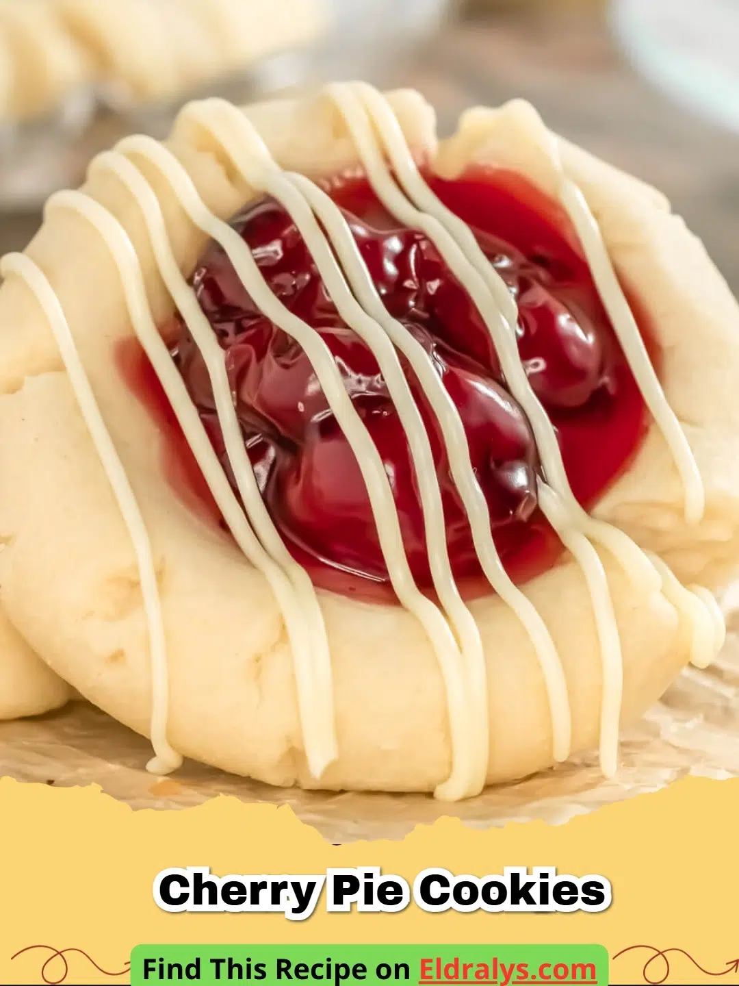 Close up of golden Cherry Pie Cookies with ruby red fruit centers on a white plate