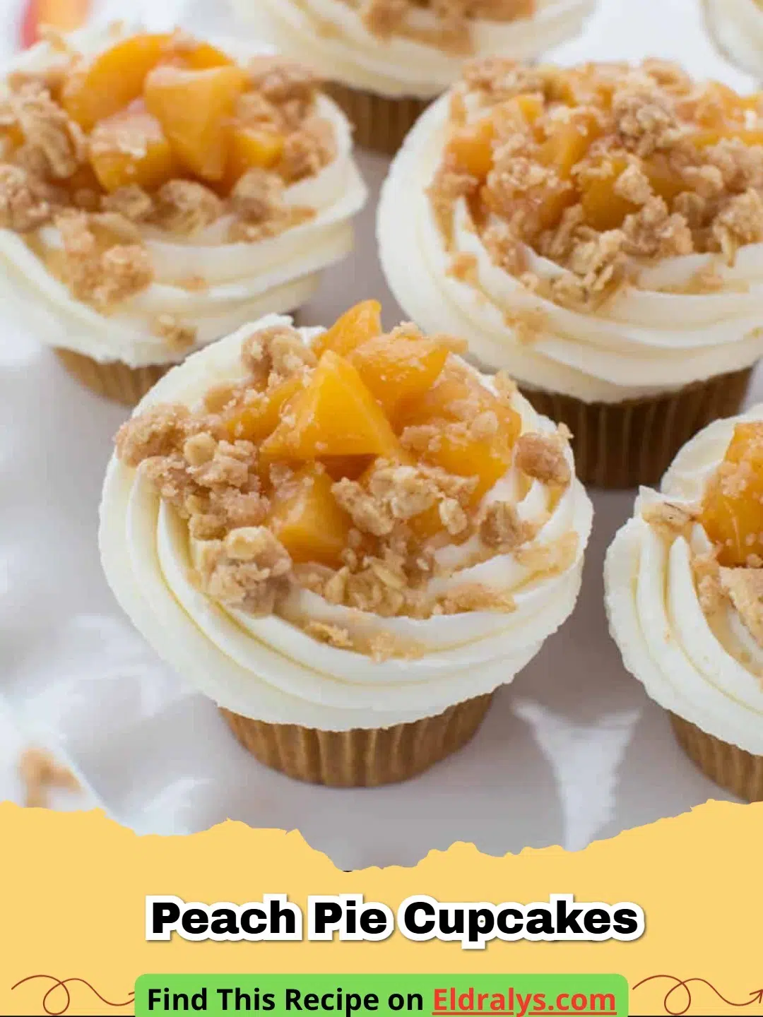 A close up of Peach Pie Cupcakes with vanilla frosting and fresh peach slices